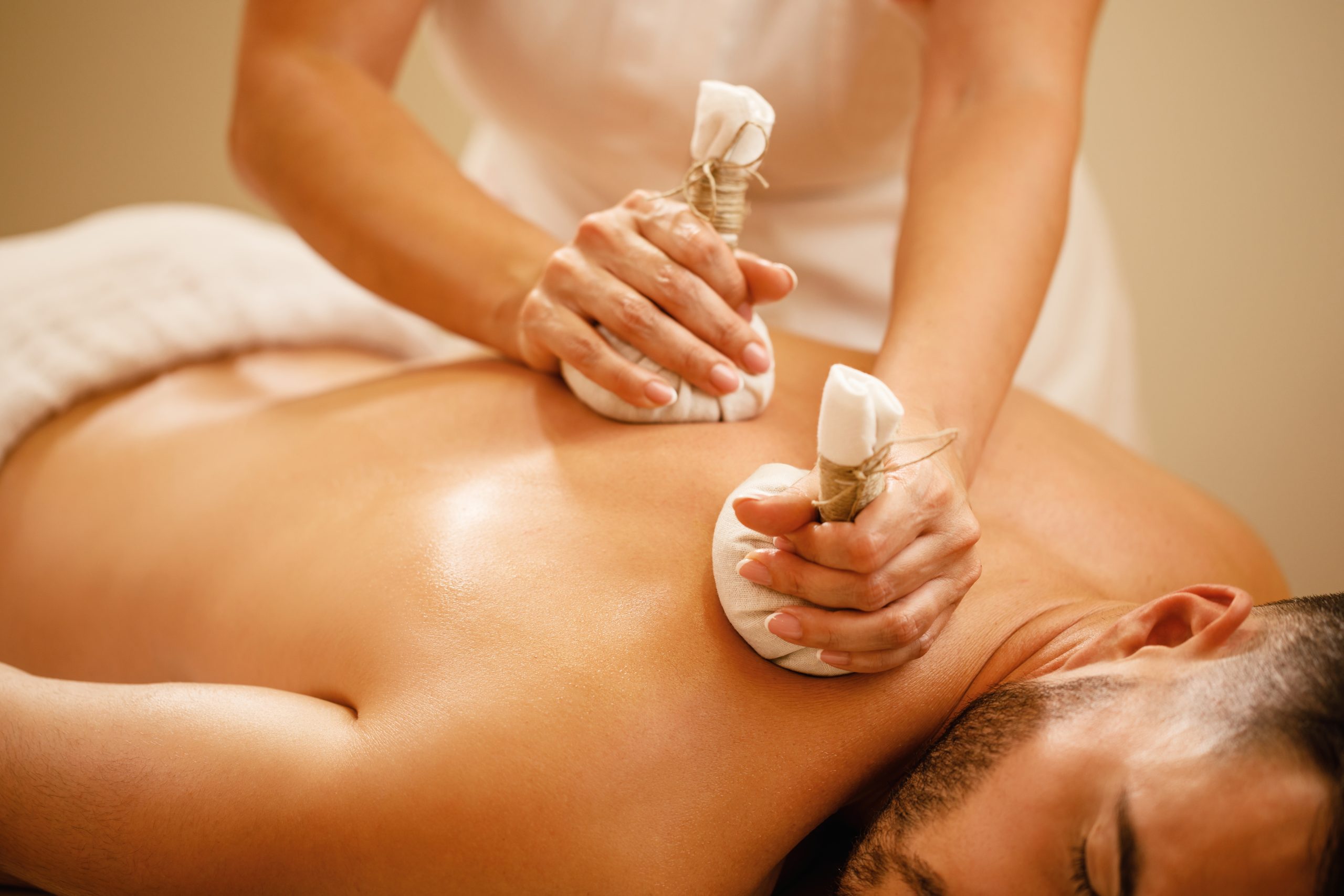 closeup-man-getting-back-massage-with-detox-herbal-balls-health-spa-scaled